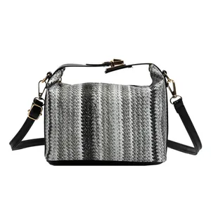 Striped straw shoulder bag with black top handles and adjustable strap in tricolor design