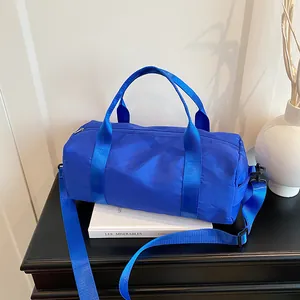 Minimalist bright blue cylinder tote bag with adjustable strap for fitness and travel