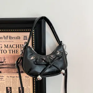 Sac croissant noir chic avec nœud décoratif et sphères métalliques argentées suspendues