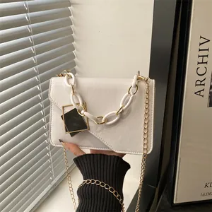 Chic cream leather flap bag with acrylic and gold chain straps for modern women