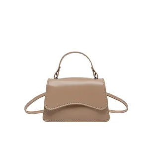 Chic khaki PU leather mini crossbody bag with unique wave flap and top handle