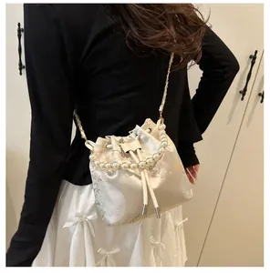 Detail of a floral jacquard bucket bag with pearl handle and chain strap for women