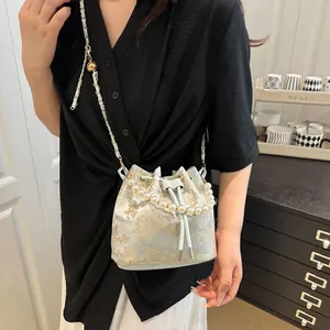 Light blue floral jacquard bucket bag with pearl handle and metal chain strap