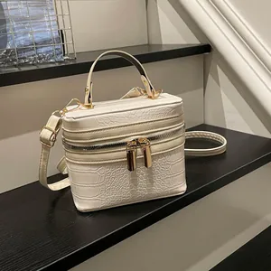 Cream white crocodile pattern box handbag with golden zippers and adjustable strap