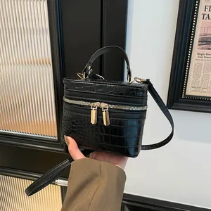 Chic black crocodile embossed box handbag with gold zippers and detachable strap