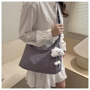 Purple faux leather shoulder bag with Tidal Dryness text and white cloud plush charm