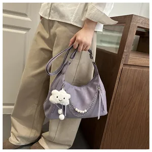 Detail of purple hobo bag with silver zippers, pearl chain, and cloud charm