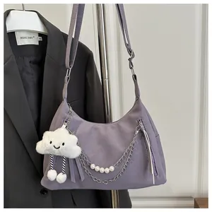 Detail of lavender crescent bag with pearl chain, tassel zip and cloud charm accent
