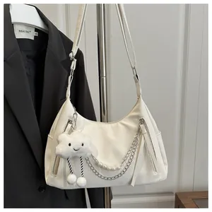 White hobo shoulder bag with pearl chain and cute cloud pendant on black blazer