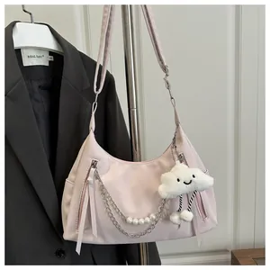 Close-up of pink hobo bag with silver chain, white pearls and a cute plush cloud charm