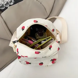 Corduroy mini crossbody bag with strawberry embroidery showing spacious interior