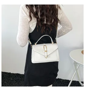 Detailed back view of model wearing a minimalist beige PU leather small crossbody bag