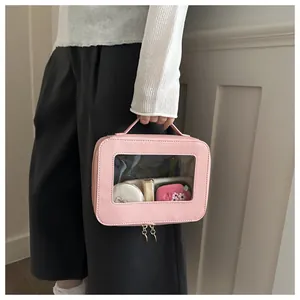 Pink portable makeup bag with a transparent front window and double zipper closure