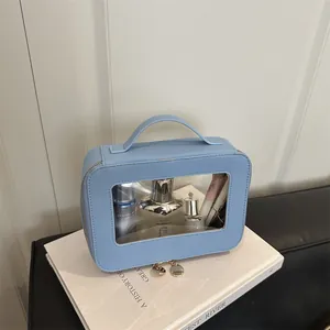 Light blue faux leather cosmetic bag with transparent window and gold zippers