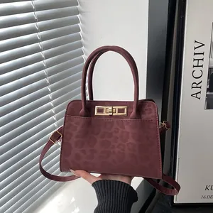 Sac à main bordeaux chic à motif léopard avec poignées et fermoir doré élégant