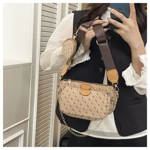 Detailed close-up of 3-in-1 crossbody bag with monogram pattern and gold chain