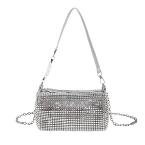 Elegant silver rhinestone clutch bag with pearl strap and polished metallic finish