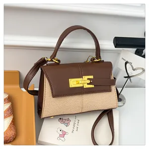Détail du sac trapèze avec rabat en cuir marron et fermoir tournant en métal doré