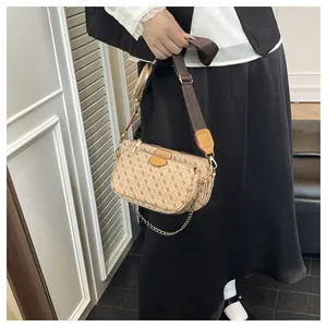Detailed shot of a 3-in-1 crossbody bag set with geometric print on a female model