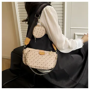 Detail of 3-in-1 monogram crossbody bag with detachable wide strap and gold chain