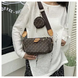 Close-up of three-in-one crossbody bag featuring brown monogram pattern and golden chain