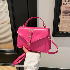 Pink PU leather crossbody flap bag with golden metal buckle and top handle for women