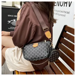 Detail of a three-in-one crossbody bag with M-pattern canvas and a round coin purse