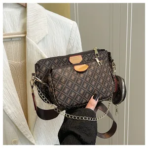 Detail of 3-in-1 coffee crossbody bag with monogram print, chain and wide strap