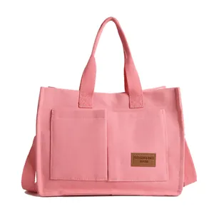 Sac fourre-tout en toile rose avec écusson logo en cuir et bandoulière réglable
