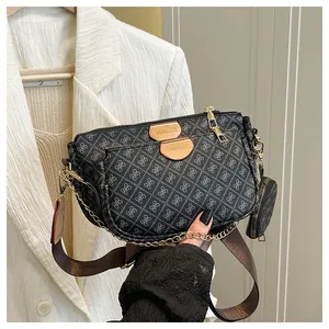 Close-up of three-in-one crossbody bag with white geometric patterns and gold chain