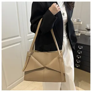 Détail d'un grand sac cabas beige avec son rabat géométrique en cuir synthétique chic