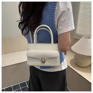 Close-up of white lychee pattern leather texture and gold oval twist lock on a handbag