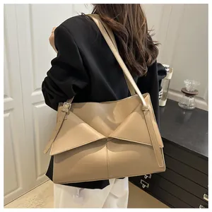 Detail view of khaki leather underarm tote bag with unique double triangle fold cover design