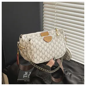 Detailed view of 3-in-1 crossbody bag set with M-pattern print and luxury gold hardware