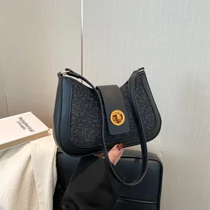 Elegant black glitter hobo shoulder bag with a vintage gold twist lock for women