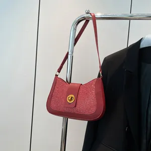 Sparkly dark red underarm bag with gold oval buckle and glittery texture for women