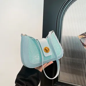 Light blue sequin underarm bag with gold twist lock and sleek leather shoulder strap