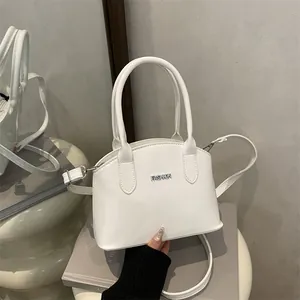 Chic white glossy mini handbag with silver metal FASHION logo and adjustable strap