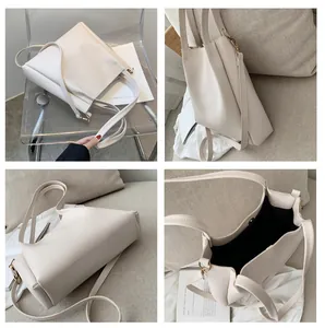 Detail view of large beige tote bag with twin handles, long strap and magnetic closure