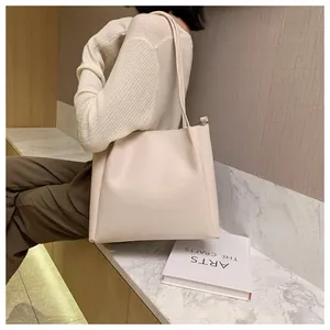 Detailed shot of cream large capacity tote bag on marble surface for daily commuting use