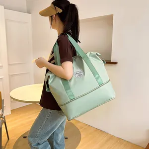 Detail of the mint green waterproof travel bag showing the bottom wet dry separation layer
