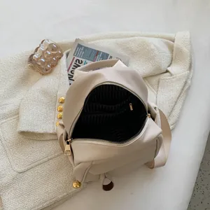 Chic off-white pebble leather backpack with gold hardware and striped fabric lining