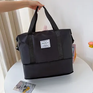 Detail of black waterproof travel bag with large capacity and separate bottom compartment