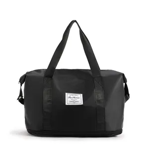 Close-up of black waterproof nylon travel bag with a dedicated bottom zipper compartment