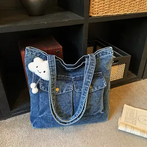 Large capacity blue denim canvas tote bag with dual front pockets and plush pendant