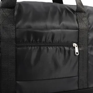 Close-up of black travel bag showing high-quality nylon fabric and durable silver zipper