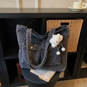 Large gray washed denim canvas tote bag with dual front pockets and cloud pendant