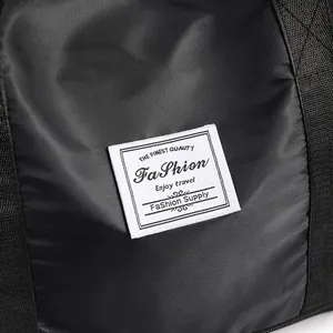 Close-up of waterproof nylon travel bag featuring white fashion logo label and texture