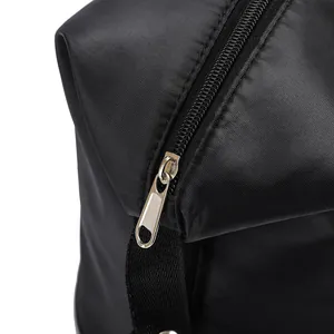 Detail of high-density nylon travel bag showing waterproof fabric and silver metal zipper