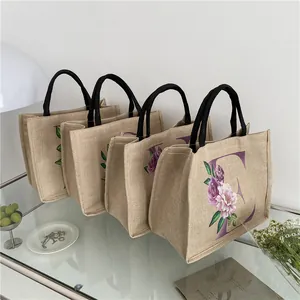Umweltfreundliche Jute-Einkaufstaschen mit Blumen-Alphabet-Druck und schwarzen Griffen